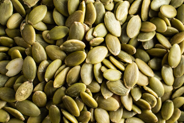 Roasted pumpkin seeds background, close up