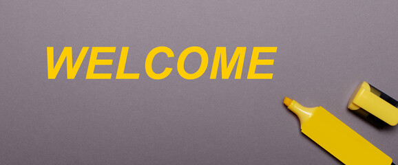 On a gray background, yellow marker and yellow inscription WELCOME © Елена Дигилевич
