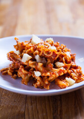 Bolognese pasta with meat in tomato sauce with parmesan cheese. Spaghetti Bolognese on white plate
