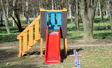 A colorful slide on a playground in a park