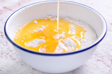 Making a shortcrust pastry adding melted butter to the flour