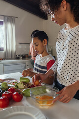 Teamwork in the kitchen. Black children helping their mother