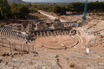 Roman amphitheatre in Ephesus, Izmir, Turkey. Grand theater ancient city. Restoration, working cranes and builders. Work on the historical steps.