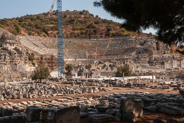 Roman amphitheatre in Ephesus, Izmir, Turkey. Grand theater ancient city. Restoration, working cranes and builders. Work on the historical heritage.