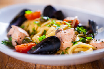 Pasta with seafood. Pasta with mussels and basil. Fresh Seafood fresh homemade pasta with mussels and parsley. Fresh Italian food. Mediterranean fresh sea food dish. Beautiful plate. fine dish