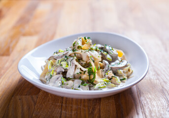 Tagliatelle pasta with asparagus mushrooms and basil in sour cream sauce. Italian pasta. fresh pasta 
culinary recipe