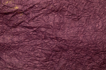 The background is made of crumpled paper in the color of Burgundy wine with gold paint.