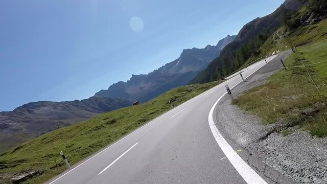 Curves driving on mountain roads by motorcycle to the Bernina Pass in Switzerland