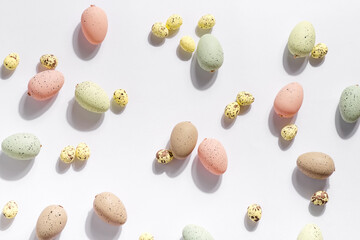 Happy Easter holiday background with colorful pastel eggs on white paper .