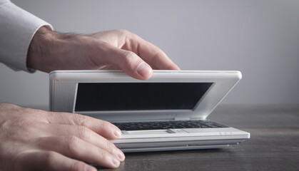 Caucasian businessman opening his laptop.