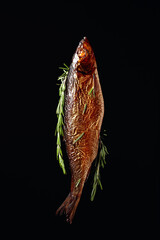 Smocked herring on a black background.