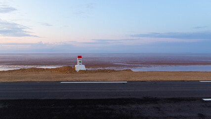 Milestone post on the Tozeur highway.  Road passes through salt lake of Chott el Djerid, Tunisia.