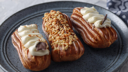 Homemade dessert glazed eclairs close up, selective focus