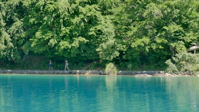 People walking in the paths of Kozjak Plitvice lake, National Park in Croatia