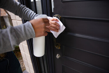Disinfecting door knob by cleaner at the entrance