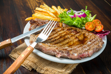 Chuleta de ternera con patatas fritas y ensalada