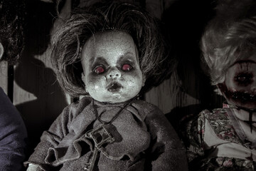 Scary portrait of a dead doll in the dark. Zombie doll.