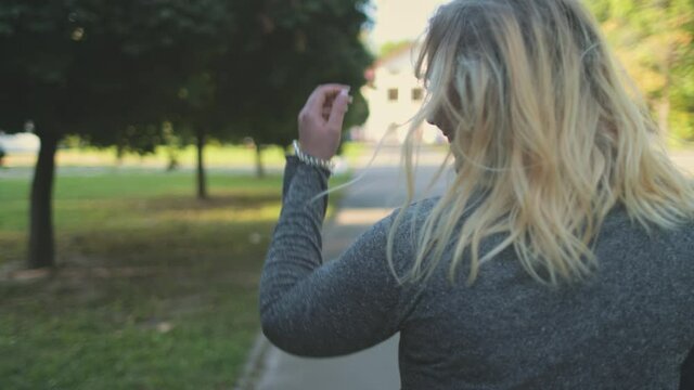 Sexy girl flirt at park closeup. Blond woman plus size walking at green trees. Body positive model