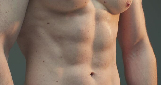 Athlete showing perfect abs muscles. Close up video of muscular naked body. Shirtless athlete
