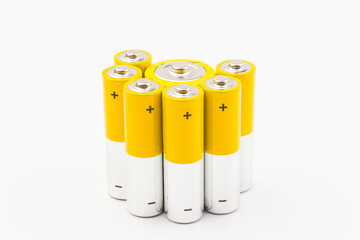 Photo of gray-yellow alkaline AA batteries on white background. Recycling of rechargeable NiMH batteries. The most popular size of accumulators. Copy space.
