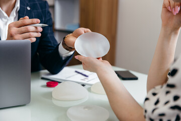 Cosmetic Surgeon Shows Female Patient Breast Implant Samples and Talk About Her Future Surgery. 