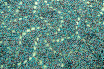 crochet thread blue green and yellow texture background closeup