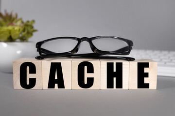 CACHE.text on wood cubes. text in black letters on wood blocks