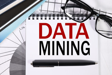 Data Mining. text on white paper on financial charts background