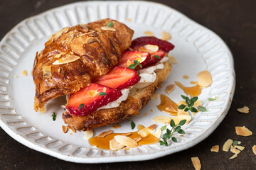 Croissant sandwich with camembert cheese   and strawberry 