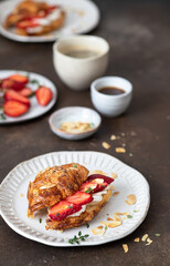 Croissant sandwich with camembert cheese  , strawberry and coffee