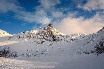 Fototapeta na wymiar Stormoa snowy peak in northern Norway in winter