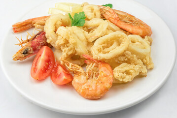 Fried calamari and shrimps on white plate