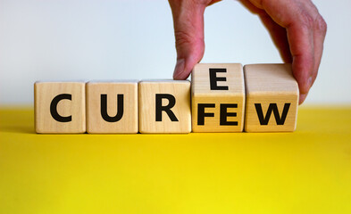 Curfew and cure symbol. Businessman turns cubes and changes the word 'curfew' to 'cure'. Beautiful...