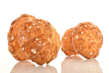 Several sweet chouquette, close-up, isolated on white.