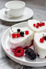 Panna Cotta with fresh berries on white plate. Delicious homemade dessert as tasty breakfast