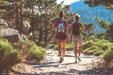group of friends hiking in the mountains. two girls walking in nature