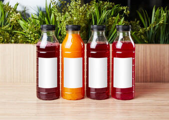 juice in plastic bottles on wooden background