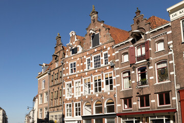 Fototapeta na wymiar Typical historic medieval exterior facades of Hanseatic city center Zutphen in The Netherlands against a clear blue sky. Europe tourism destination.