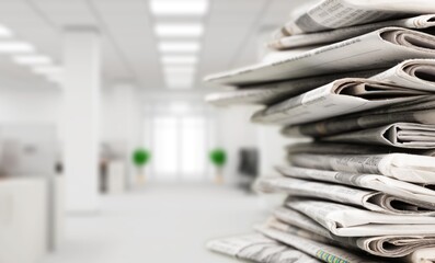 Pile of newspapers stacks on blur background