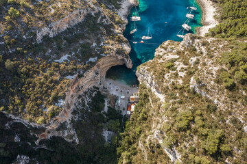 Aerial drone shot of Stiniva cove beach of Adriatic sea on Vis Island in Croatia summer