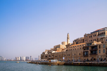 Obraz premium Tel Aviv-Jaffo, Israel - March 15, 2021: Panoramic view of Jaffa's ancient port. Located to the south and known as an ancient port city. View of the St. Peter's Church. Jaffa is part of Tel Aviv