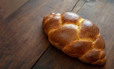 Easter tsoureki braid, greek easter sweet bread, on wooden background