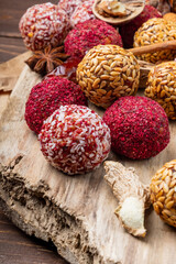 Energy balls on an old natural wood board. Close-up. Selective focus.