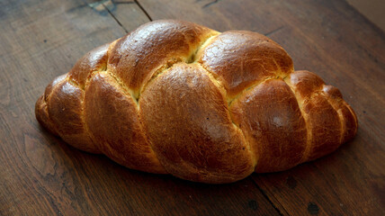 Easter tsoureki braid, greek easter sweet bread, on wooden background