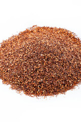 Pile of natural rooibos tea with leaves on white background. Rooibos tea, strawberries.