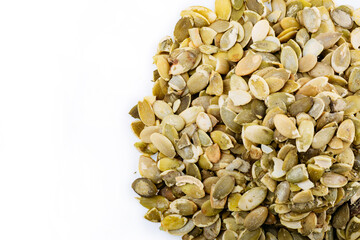 Heap of fresh shelled pumpkin seeds isolated on white. Peeled pumpkin seeds.