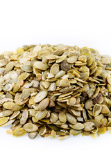 Heap of fresh shelled pumpkin seeds isolated on white. Peeled pumpkin seeds.