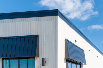 The exterior surface of an aluminum metal composite panel wall of a contemporary business. The...