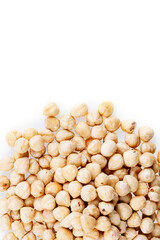 Roasted hazelnuts. A bunch of hazelnuts on a white background. Raw hazelnuts isolated over white background. Roasted hazelnuts background.