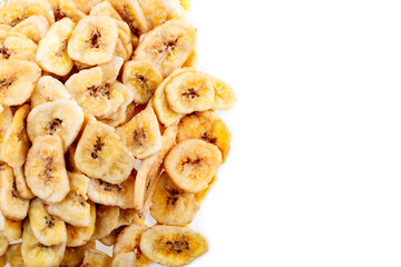Dried bananas. Banana chips, dehydrated slices of fresh ripe bananas as food background.